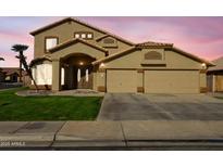 Charming home with a well-manicured lawn, arched entryway, and a spacious two-car garage at 638 W Nido Ave, Mesa, AZ 85210