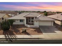 Single-story home with desert landscaping and a two-car garage at 8309 E Navarro Ave, Mesa, AZ 85209