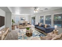 Bright living room featuring modern decor, ample natural light, and stylish furnishings at 14210 N 135Th Dr, Surprise, AZ 85379