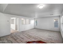 Bright living room with neutral carpeting and hardwood accents at 14210 N 135Th Dr, Surprise, AZ 85379