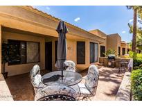 Spacious patio with seating area, umbrella, and grill at 14300 W Bell Rd # 207, Surprise, AZ 85374