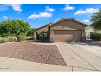 Single-story house with a two-car garage and desert landscaping at 15325 W Port Au Prince Ln, Surprise, AZ 85379