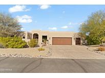 Stunning desert home with a large front yard, two-car garage, and attractive landscaping at 18702 E Gemmill Dr, Rio Verde, AZ 85263