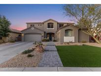 Two-story house with gray exterior, landscaped yard, and a three-car garage at 1918 W Bonanza Ln, Phoenix, AZ 85085