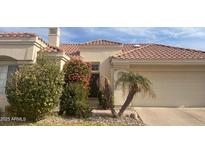 Tan two-story house with tile roof, landscaping, and two-car garage at 2127 W Peninsula Cir, Chandler, AZ 85248