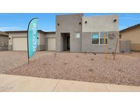 Modern home with a two-car garage, desert landscaping and a welcoming entryway at 22670 E Happy Rd, Queen Creek, AZ 85142