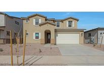 Two-story home with a two-car garage, desert landscaping, and a welcoming front entrance at 23136 E Watford Dr, Queen Creek, AZ 85142