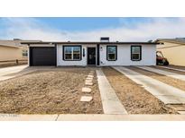 White house with black garage door and landscaping at 2317 W Danbury Rd, Phoenix, AZ 85023