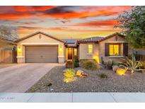 Single-story home with desert landscaping and a two-car garage at 30255 N 115Th Dr, Peoria, AZ 85383