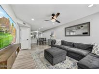 Spacious living room with L-shaped sectional sofa and large TV at 3301 E Earll Dr # 102, Phoenix, AZ 85018