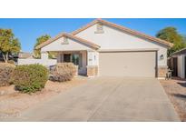 Single-story home with front yard landscaping and a two-car garage at 34403 N Damietta Trl, San Tan Valley, AZ 85143