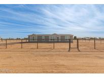 Single-story home with a fenced yard at 36735 W Harrison St, Tonopah, AZ 85354