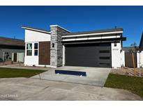 Modern home exterior with gray stone and a two-car garage at 3752 W Antelope Way, San Tan Valley, AZ 85144