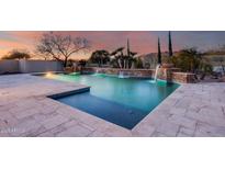 Stunning pool with waterfall feature and spacious tanning area at 3756 E Galvin St, Cave Creek, AZ 85331