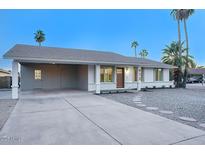 Newly remodeled home with carport and a nicely landscaped front yard at 413 W Marco Polo Rd, Phoenix, AZ 85027