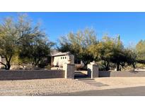 One-story home with desert landscaping and a gray stucco wall at 5950 E Lowden Ct, Cave Creek, AZ 85331