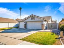 House exterior with three-car garage and landscaped lawn at 731 N Nantucket St, Chandler, AZ 85225