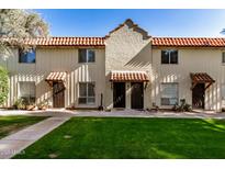 Front view of charming Spanish-style home with tile roof, and landscaped lawn at 8241 N Central Ave # 32, Phoenix, AZ 85020