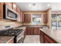 View of kitchen with gas range and stainless steel appliances at 8841 W Cordes Rd, Tolleson, AZ 85353