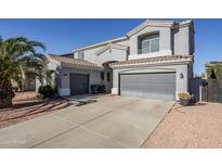 Two-story house with a large driveway and desert landscaping at 10406 E Laguna Azul Ave, Mesa, AZ 85209