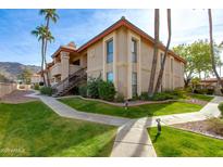 Attractive exterior of a two-story condo with landscaped grounds at 10410 N Cave Creek Rd # 2011, Phoenix, AZ 85020