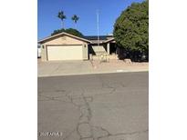 Single story home with attached two car garage and mature landscaping at 1724 W 15Th Ave, Apache Junction, AZ 85120