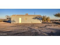 Rear view of a single-story house with a spacious yard at 1814 S 363Rd Ave, Tonopah, AZ 85354