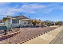 Single-story home with desert landscaping and a large front yard at 18625 N 103Rd Ave, Sun City, AZ 85373