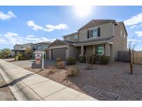 Two-story house with gray siding, a three-car garage, and a landscaped front yard at 2071 E Piedmont Pl, Casa Grande, AZ 85122