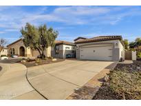 Single-story home with a two-car garage and nicely landscaped yard at 5089 S Harvest St, Gilbert, AZ 85298