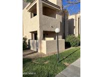 Two-story condo building with light-colored exterior and landscaping at 7510 E Thomas Rd # 134, Scottsdale, AZ 85251