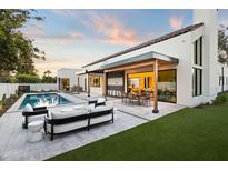 Stunning backyard with a pool, patio, and outdoor seating, perfect for entertaining and relaxation at 8255 E Morgan Trl, Scottsdale, AZ 85258
