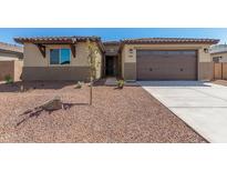 New construction home with two-car garage and desert landscaping at 8569 N 175Th Ln, Waddell, AZ 85355