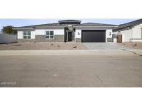 Modern single-story home with stone accents and a two-car garage at 10229 N 177Th Dr, Waddell, AZ 85355