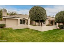 Beautiful front yard featuring a well-maintained lawn and attractive landscaping at 10417 E Becker Ln, Scottsdale, AZ 85259