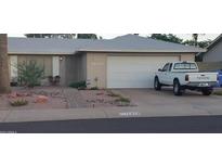 Ranch style home with a two-car garage and well-maintained landscaping at 11015 S Bannock St, Phoenix, AZ 85044