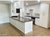 Modern kitchen with white cabinets, granite counters, and stainless steel appliances at 1816 E Palmcroft Dr, Tempe, AZ 85282