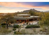Luxury home with expansive backyard and mountain views at sunset at 34587 N Ironwood Rd, Scottsdale, AZ 85266