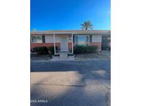 Brick ranch home with front yard landscaping, and a paved driveway at 524 W Fairway Dr # 12, Mesa, AZ 85201