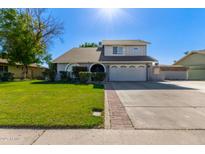 Two-story house with a gray exterior, two-car garage, and landscaped lawn at 6113 W Desert Hills Dr, Glendale, AZ 85304