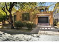 Brick home with attached garage and mature landscaping at 9439 E Trailside Vw, Scottsdale, AZ 85255