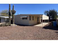 Tan mobile home with covered patio and desert landscaping at 13013 N 19Th Pl, Phoenix, AZ 85022