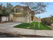 Charming two-story home features a well-manicured lawn, attached garage, and inviting facade at 13441 W Rose Ln, Litchfield Park, AZ 85340