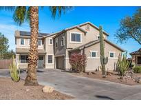 Two-story house with desert landscaping and a large driveway at 16118 W Gibson Ln, Goodyear, AZ 85338