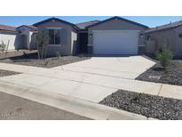 Single-story home with a two-car garage and desert landscaping at 17215 W Corrine Dr, Surprise, AZ 85388