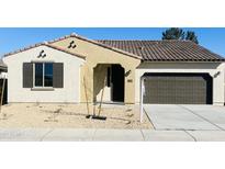 New stucco home with tile roof, 2-car garage, and desert landscaping at 17469 N 66Th Ave, Glendale, AZ 85308