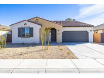 Charming single-story home with neutral stucco, tidy xeriscaping, and a two-car garage at 17469 N 66Th Ave, Glendale, AZ 85308