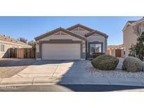 Charming single-story home with a two-car garage and well-manicured landscaping at 18487 N 111Th Dr, Surprise, AZ 85378