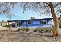 Single-story home featuring a blue facade, desert landscaping with rocks and drought tolerant bushes at 1905 W 2Nd St, Mesa, AZ 85201