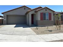 Single-story home with gray exterior, red shutters, and a two-car garage at 20863 N 223Rd Ave, Surprise, AZ 85387